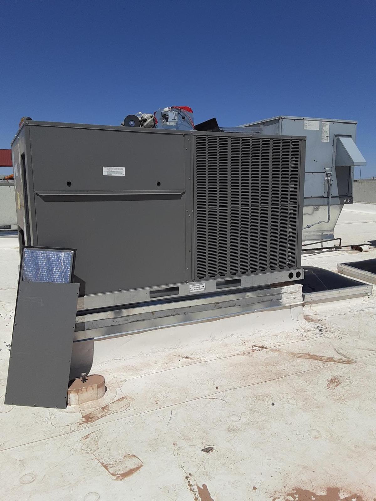 Israel Sheet Metal technician performing HVAC maintenance on an El Paso rooftop unit